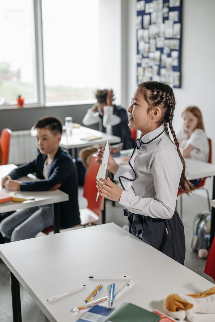Young students attentively participating in a classroom activity, fostering learning and education.